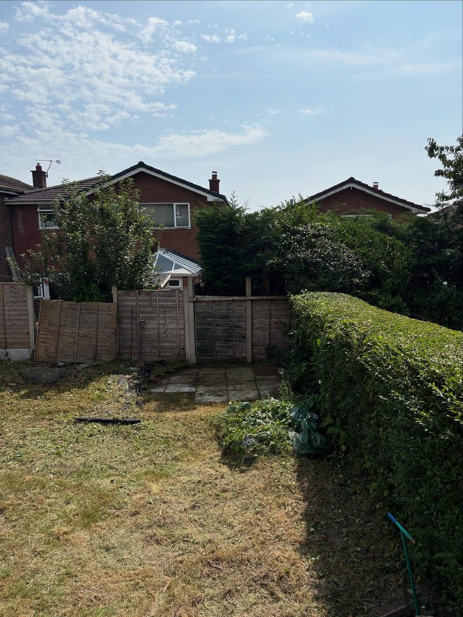 The garden stripped back to the lawn and fence
