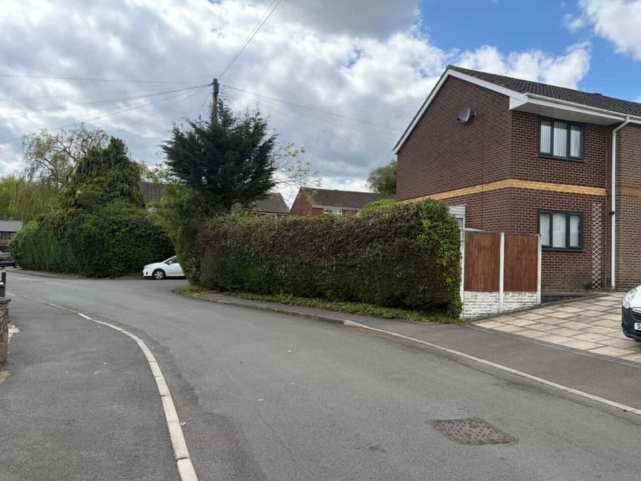 The same corner, the hedge cut back level and the pavement clear