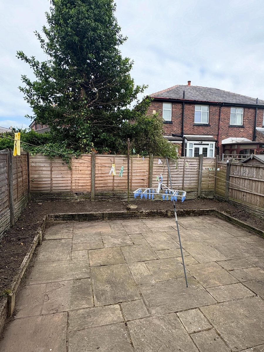 A back yard cleared, the flags swept clean inside the fence