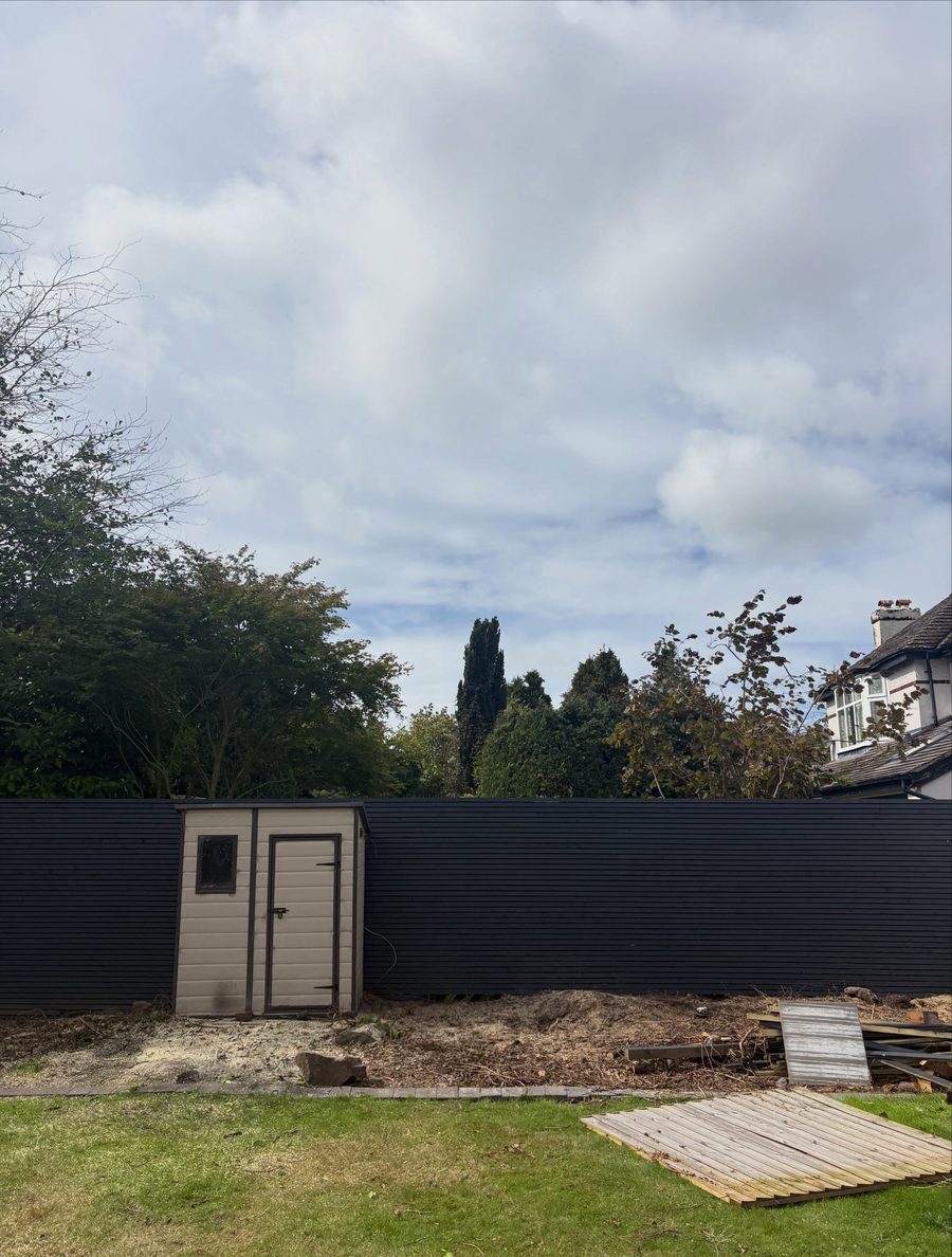 The same bed cleared to bare soil, the shed and fence now visible